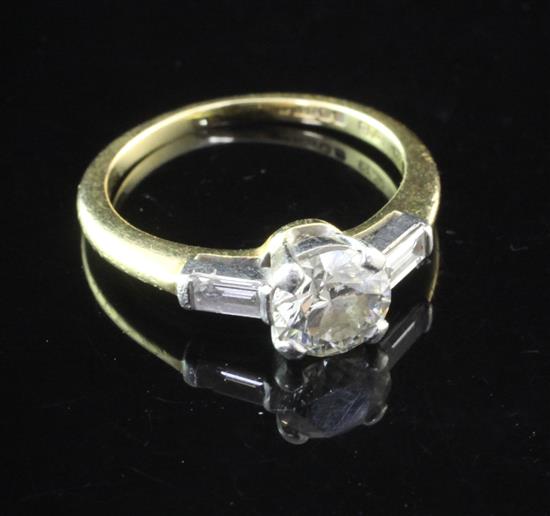 An 18ct gold and platinum single stone diamond ring with baguette cut diamond set shoulders, size K.